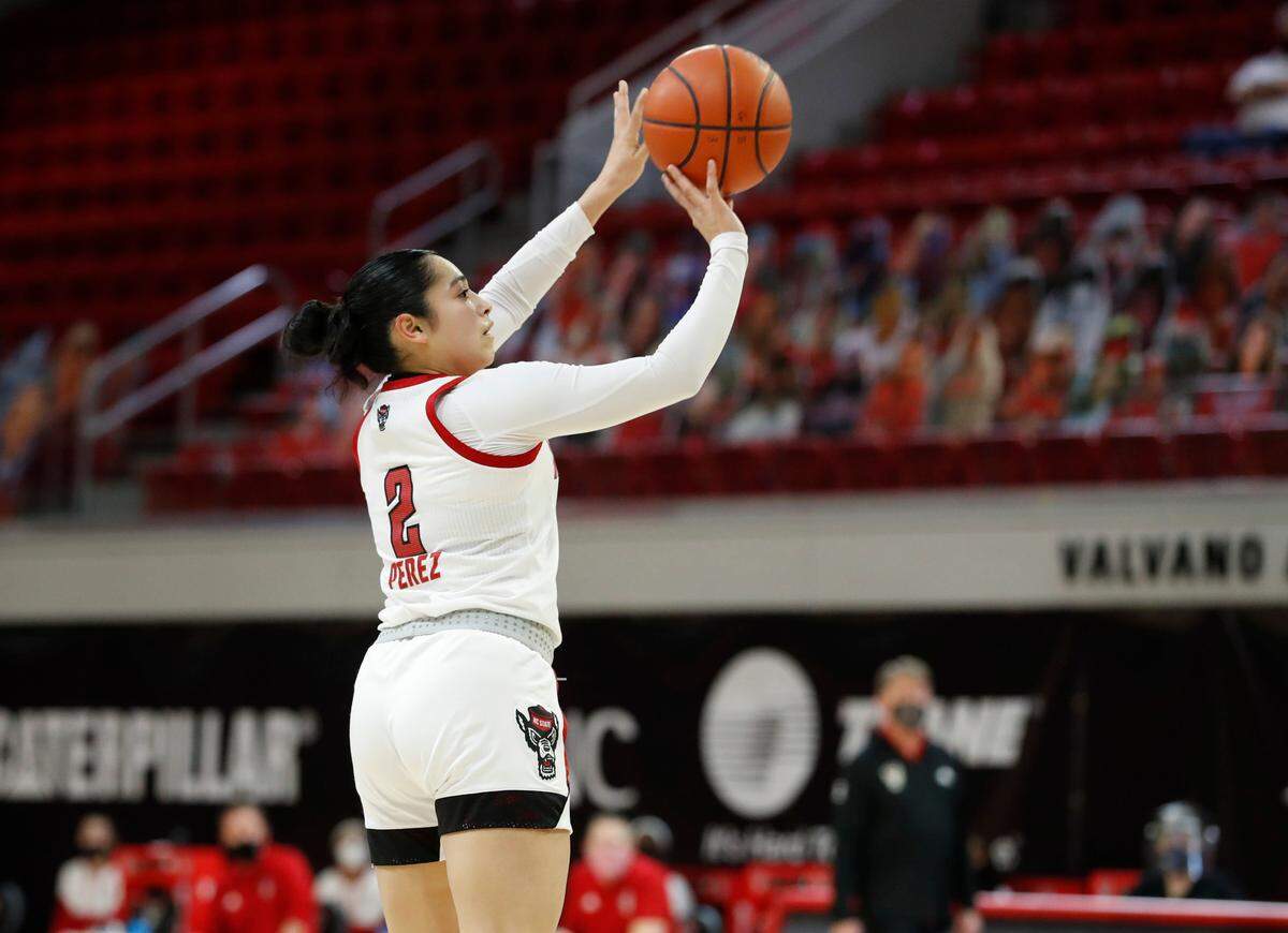N.C. State’s Raina Perez (2) hits a three-pointer during the first half of N.C. State’s game against Pittsburgh at Reynolds Coliseum in Raleigh, N.C., Thursday, February 25, 2021.