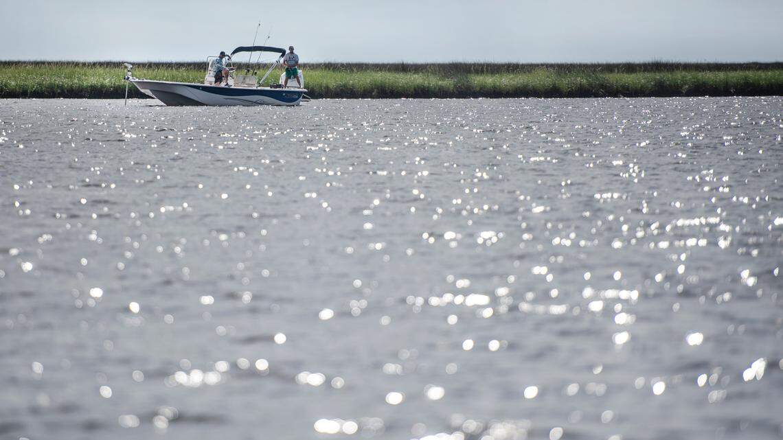 Fishermen fish off a boat at Grand Bay National Estuarine Research Reserve on Wednesday, Sept. 22, 2021.