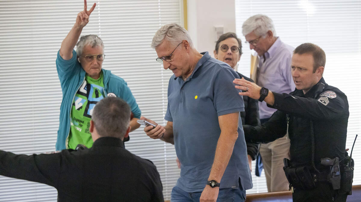 Demonstrators are removed from the gallery of the N.C. House as they loudly denounce Senate Bill 249, a bill to realign the North Carolina congressional districts, on Wednesday, October 22, 2025 at the General Assembly in Raleigh, N.C. The bill passed 66-48.