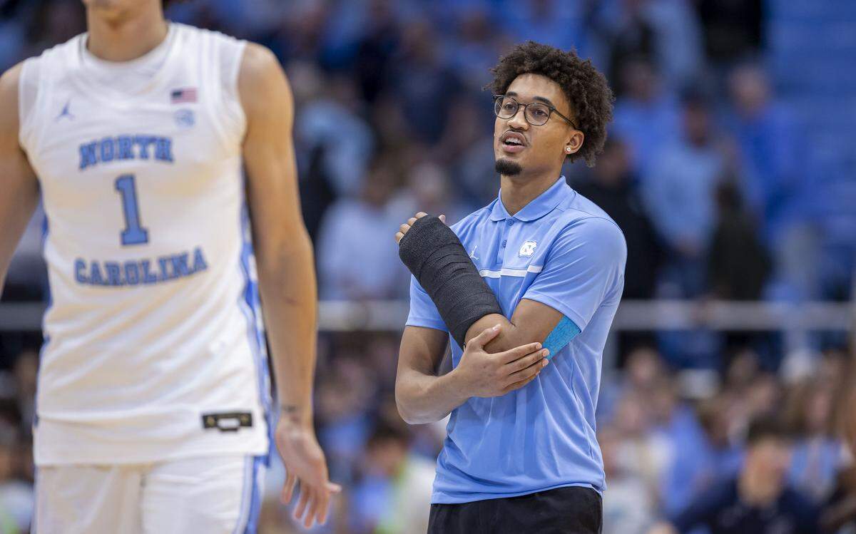North Carolina guard Seth Trimble, out after breaking a bone in his left arm, encourages his teammates, including forward Zayden High (1), during the Tar Heels’ pre-game warm ups ahead of their game against Navy on Tuesday, November 18, 2025 at the Smith Center in Chapel Hill, N.C.