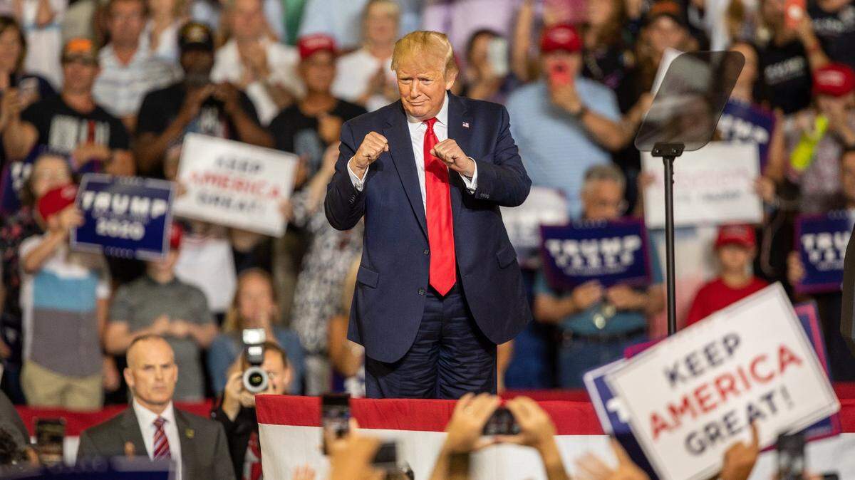 Then-President Donald Trump works the crowd during a campaign rally July 17, 2019 at East Carolina University in Greenville, NC.