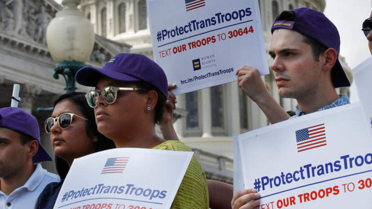 Steven McCarty, right, and others, attends an event in support of transgender members of the military, Wednesday, July 26, 2017, on Capitol Hill in Washington, after President Donald Trump said he wants transgender people barred from serving in the U.S. military “in any capacity,” citing “tremendous medical costs and disruption.” (AP Photo)