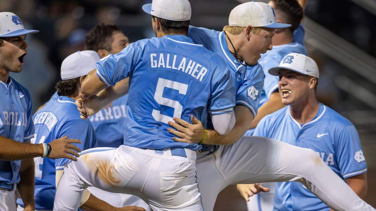 North Carolina third baseman Gavin Gallaher (5) embraces first baseman Parks Harber (14) as they celebrate their 4-3 victory over LSU in the 10th inning, clinching the NCAA Regional final on Monday, June 3, 2024 at Boshamer Stadium in Chapel Hill, N.C.