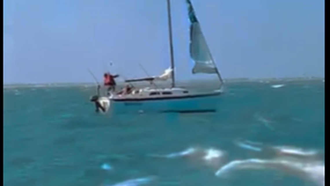 This scene from the video shows the last of the 3 mariners jumping from the disabled boat into the ocean.