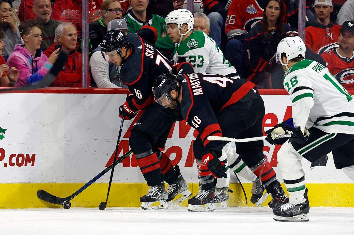 Carolina Hurricanes’ Brady Skjei (76) and Jordan Martinook (48) try to protect the puck from Dallas Stars’ Esa Lindell (23) and Joe Pavelski (16) during the first period of an NHL hockey game in Raleigh, N.C., Saturday, Dec. 17, 2022. (AP Photo/Karl B DeBlaker)