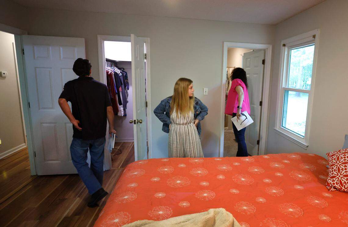 From left, Brandon Thomas, his fiancee Corinne Enlow and realtor AnnMarie Janni look over a home in Clayton while touring houses for sale in Garner and Clayton, N.C. on Tuesday, May 2, 2023.