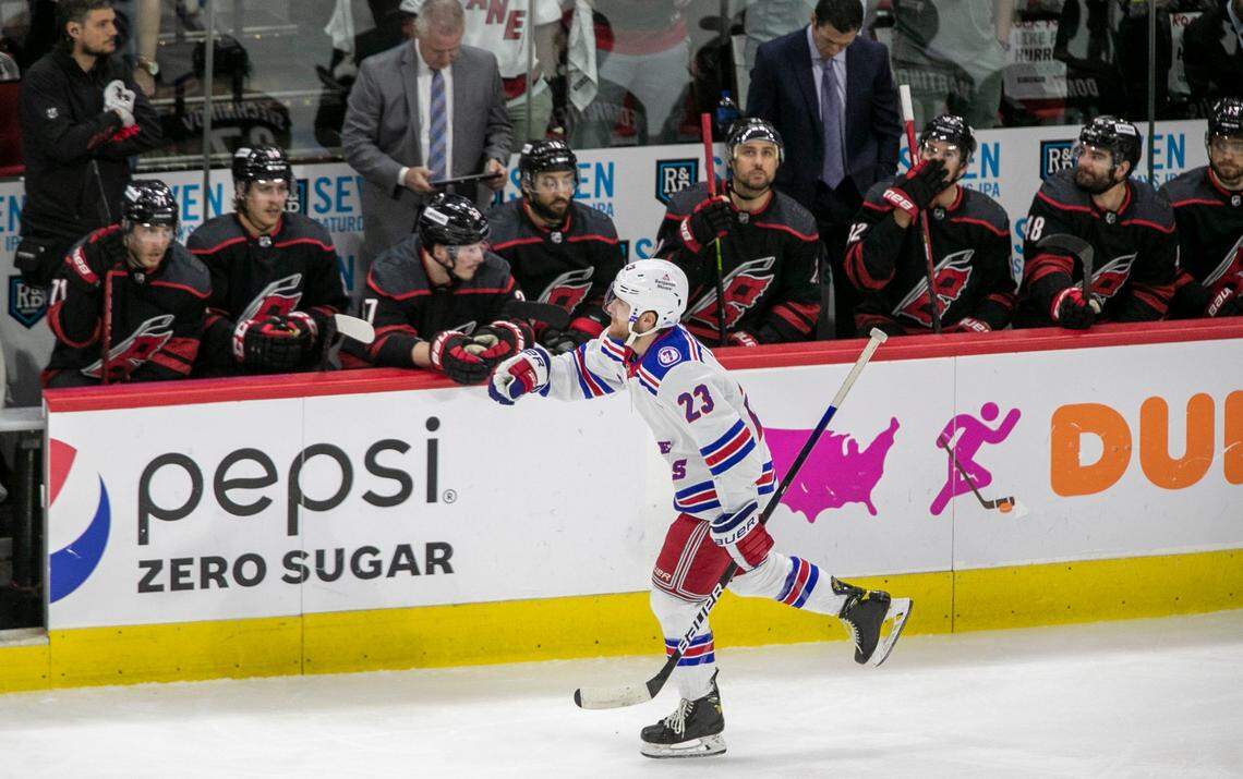 New York Rangers Adam Fox (23) reacts after scoring in the first period as he skates past the Carolina Hurricanes bench on Monday, May 30, 2022 during game seven of the Stanley Cup second round at PNC Arena in Raleigh, N.C.