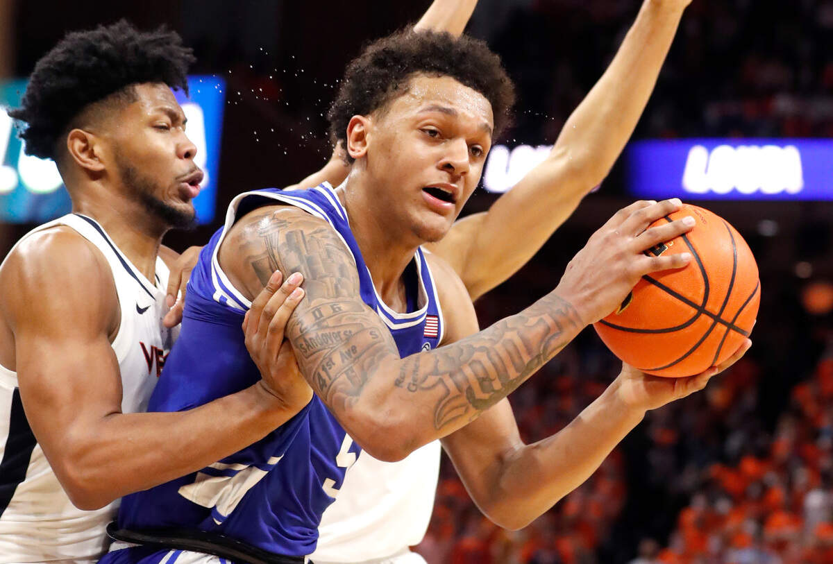 Duke’s Paolo Banchero (5) is defended by Virginia’s Jayden Gardner (1) during the first half of Duke’s game against Virginia at John Paul Jones Arena in Charlottesville, VA, Wednesday, Feb. 23, 2022.