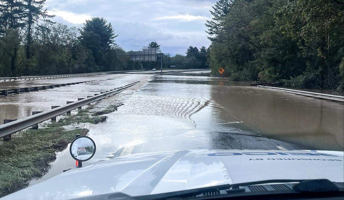Water from the French Broad River covers Interstate 40 just east of where it crosses the river on Friday, Sept. 27, 2024, after the remnants of Hurricane Helene passed through Western North Carolina. The N.C. Department of Transportation’s flood prediction system warned the river would cover the highway here.