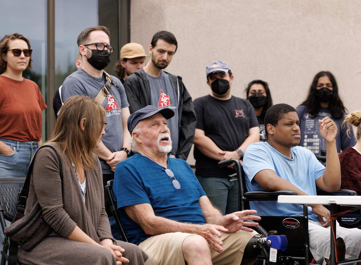 Dale Weldele, center, joined other displaced residents of Camelot Village for a press conference on Wednesday, Aug. 20, 2025, in Durham, N.C. Weldele died seven days later from a heart attack.
