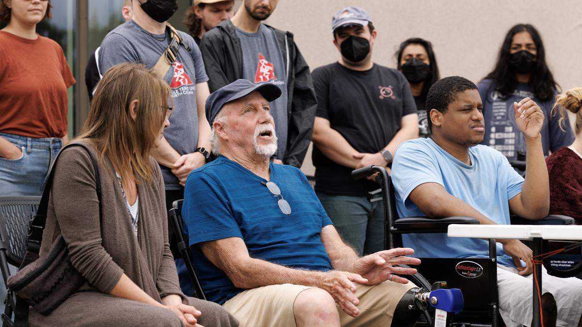 Dale Weldele, center, joined other displaced residents of Camelot Village for a press conference on Wednesday, Aug. 20, 2025, in Durham, N.C. Weldele died seven days later from a heart attack.