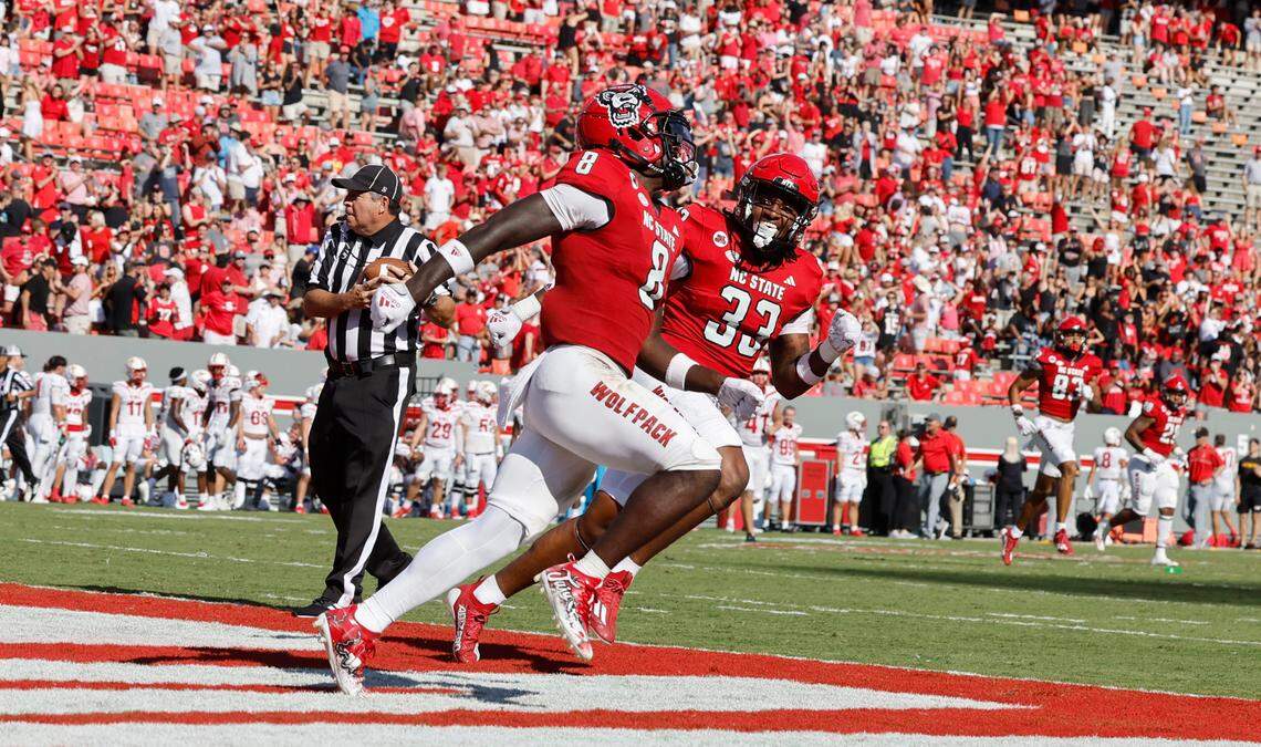 N.C. State’s Jordan Poole (33) celebrates with Julian Gray (8) after Gray scored a touchdown on a 82-yard kickoff return during the second half of the Wolfpack’s 45-7 victory over VMI at Carter-Finley Stadium in Raleigh, N.C., Saturday, Sept. 16, 2023.