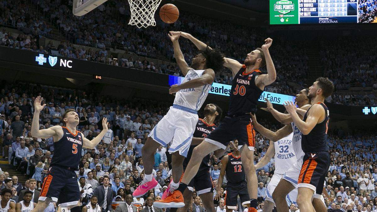 Virginia’s Jay Huff (30) blocks a shot by North Carolina’s Coby White (2) during the closing minutes of the second half on Monday, February 11, 2019 at the Smith Center in Chapel Hill, N.C.