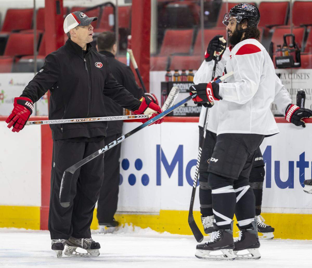 Carolina Hurricanes coach Rod Brind’Amour talks with defenseman Jalen Chatfield (5) during practice on Friday, May 15, 2026 at Lenovo Center in Raleigh, N.C.