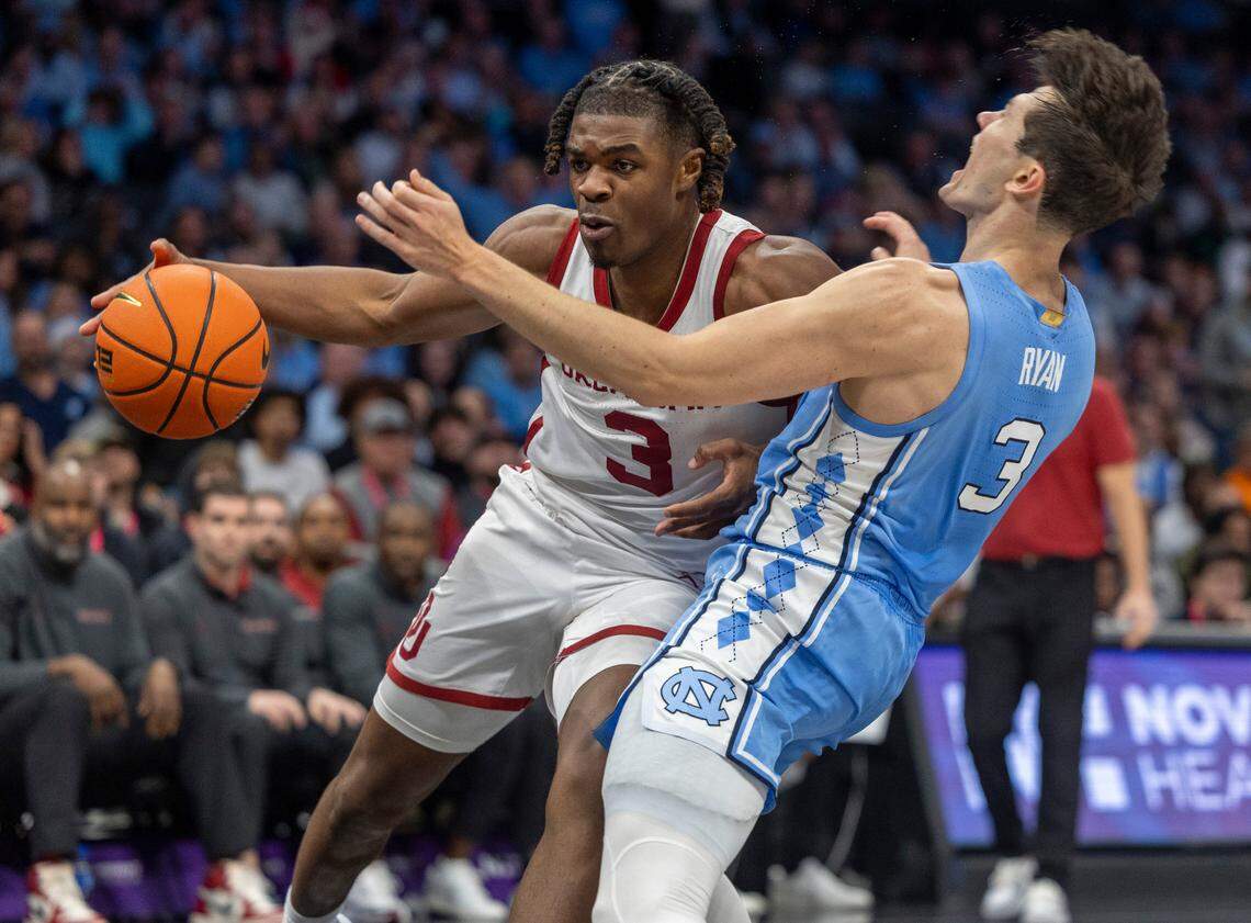 Oklahoma’s Otega Oweh (3) collides with North Carolina’s Cormac Ryan (3) in the first half on Wednesday, December 20, 2023 at the Spectrum Center in Charlotte, N.C. Ryan was called for a blocking foul on the play.