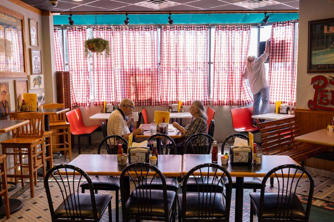 Grady Hite and his wife Annette Hite of Winston-Salem make their regular stop for lunch at Speedy’s Barbecue on Tuesday, October 10, 2023 in Lexington, N.C. Speedy’s employee Shannon Ward steps into a booth to illuminate the open sign at 11 a.m.