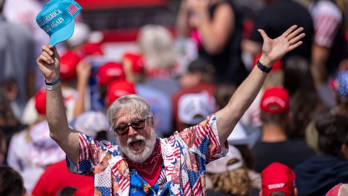 A Supporter cheers during an outdoor rally for former President Donald Trump and his running mate JD Vance at the North Carolina Aviation Museum & Hall of Fame in Asheboro, NC on Wednesday, Aug. 21, 2024.