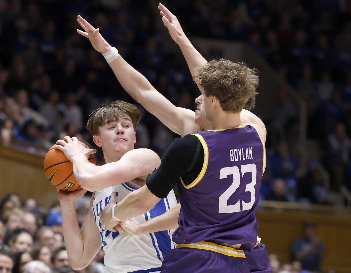 Duke’s Nikolas Khamenia looks to pass around Lipscomb's Kellan Boylan and Lipscomb's Titas Sargiunas during the first half of the Blue Devils’ game on Tuesday, Dec. 16, 2025, at Cameron Indoor Stadium in Durham, N.C.