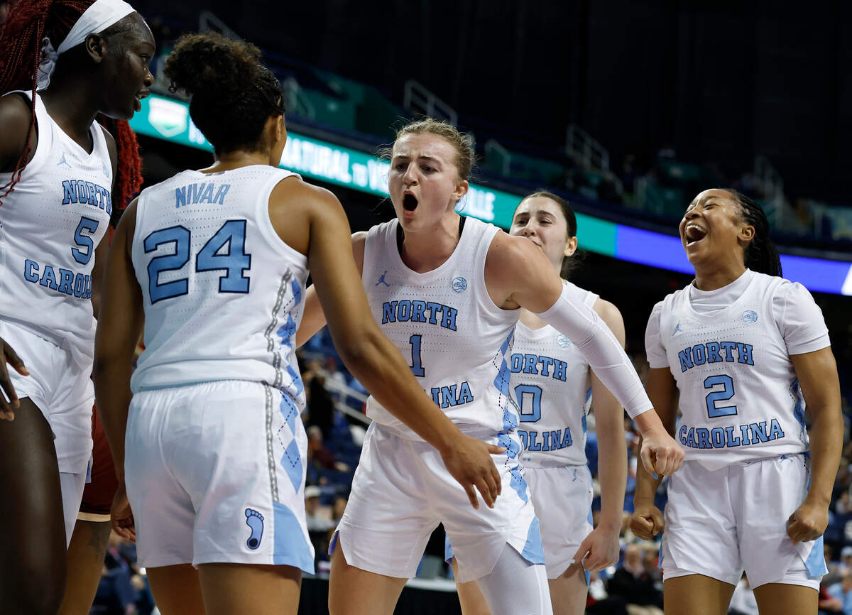 North Carolina’s Alyssa Ustby, center, celebrates after Indya Nivar was fouled during the second half of the Tar Heels’ 78-71 win over Boston College in the ACC Tournament on Thursday, March 6, 2025, at First Horizon Coliseum in Greensboro, N.C.