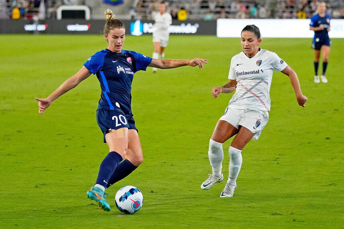 San Diego Wave FC defender Christen Westphal (20) kicks the ball against North Carolina Courage midfielder Debinha (10) during the second half at Snapdragon Stadium.