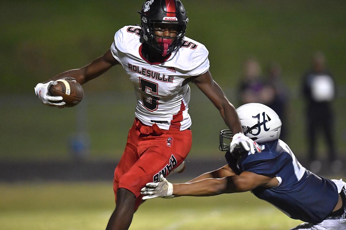 Rolesville’s Noah Rogers (5) runs for yardage against Hillside’s Jahkhem Edwards (29) in the second half. The Durham Hillside Hornets and the Rolesville Rams met in a football game in Durham, N.C. on September 9, 2022.