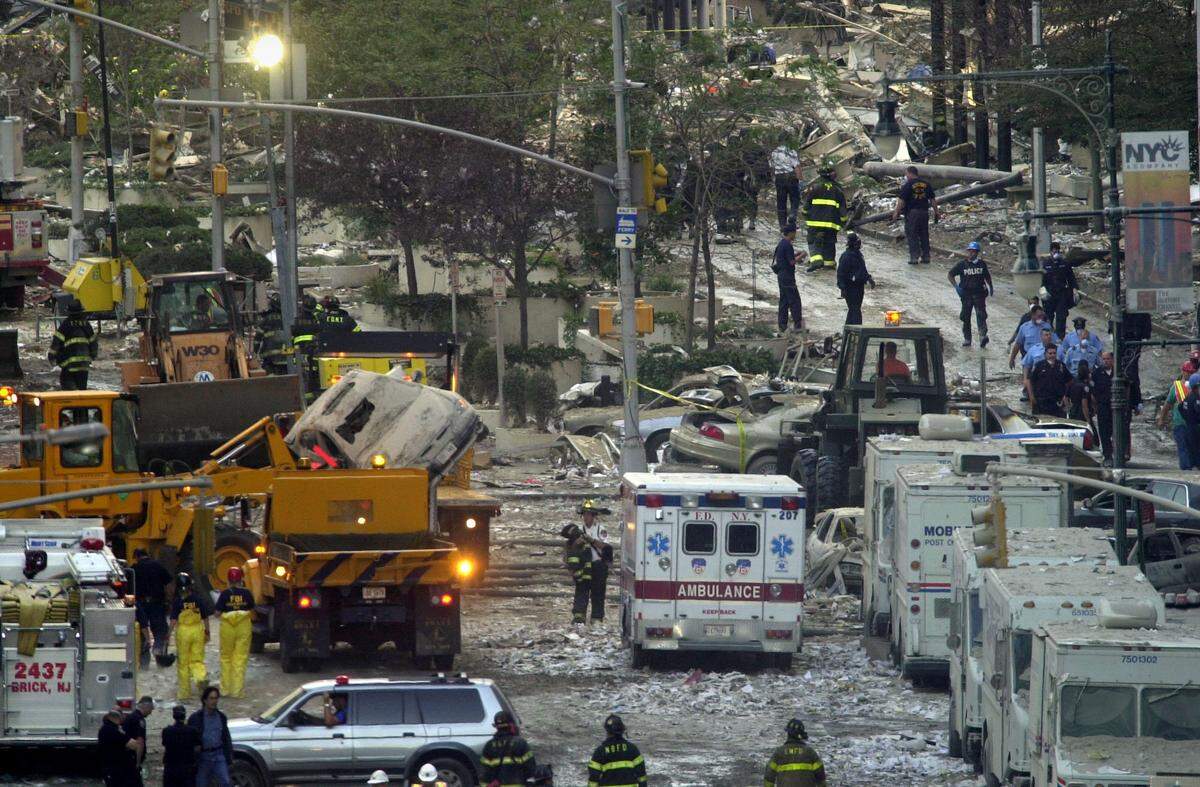 Firefighters, rescue workers and other personnel work on clearing the area near the World Trade Center Twin Towers in downtown New York Wednesday, Sept. 12, 2001.