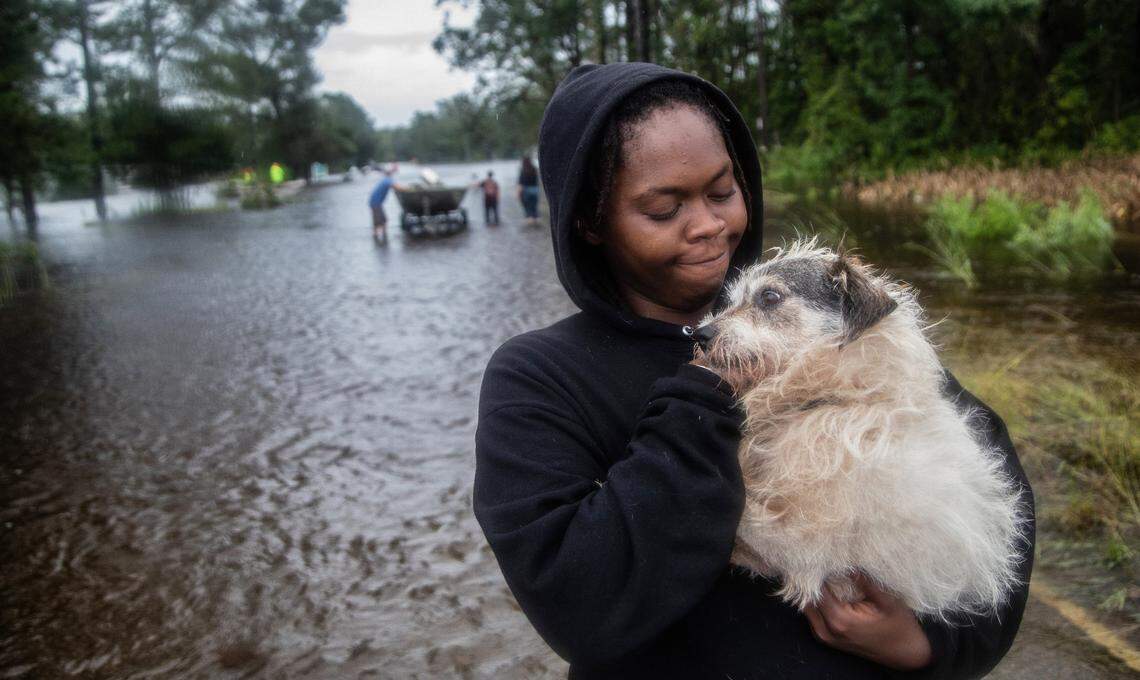 Veronica Henderson, 31, of Kinston is reunited with her dog ‘Grandpaw’ after he was rescued from rising flood waters in Kinston Saturday, Sept. 15, 2018 following the aftermath of Hurricane Florence. Volunteers rescued 18 dogs from a flood-prone neighborhood.