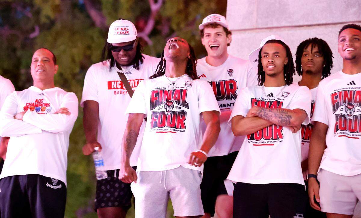 N.C. State’s DJ Horne, center, and the team watch highlights from the postseason during a celebration for the N.C. State men’s and women’s basketball team at the Memorial Belltower in Raleigh, N.C., Monday, April 15, 2024. Both teams made it to the NCAA Tournament Final Four and the men’s team won the ACC Championship by winning five games in five days.