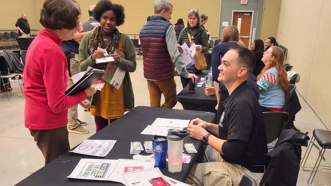 People participate at a simulation of reentering life after being incarcerated, held by Chatham County Court Services on Tuesday, Dec. 19, 2023.
