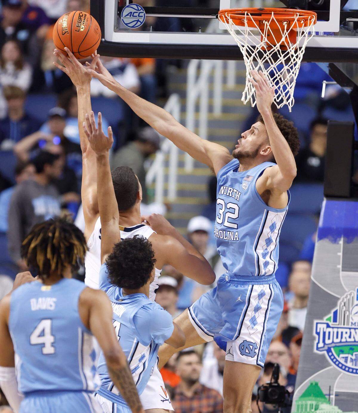 North Carolina’s Pete Nance (32) blocks the shot by Virginia’s Kadin Shedrick (21) during the first half of UNC’s game against Virginia in the quarterfinals of the ACC Men’s Basketball Tournament in Greensboro, N.C., Thursday, March 9, 2023.