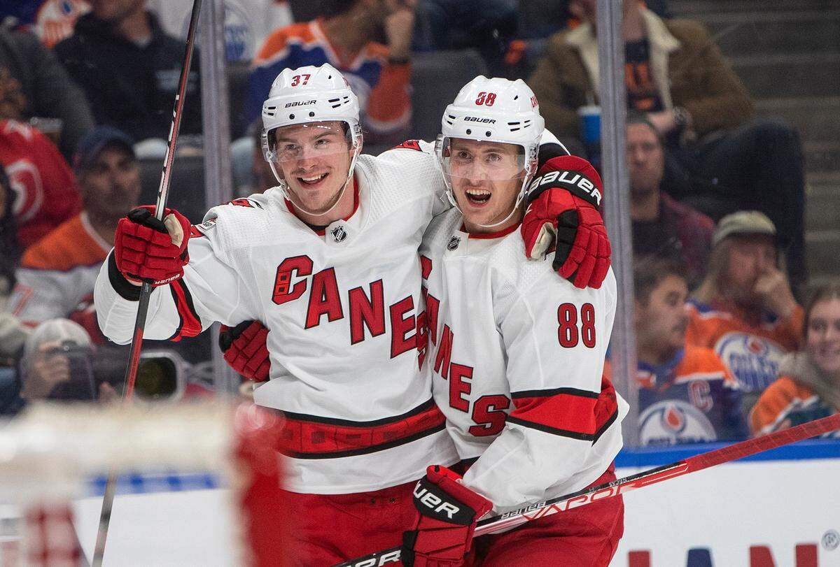Carolina Hurricanes’ Andrei Svechnikov (37) and Martin Necas (88) celebrate a goal against the Edmonton Oilers during the third period of an NHL hockey game Thursday, Oct. 20, 2022, in Edmonton, Alberta. (Jason Franson/The Canadian Press via AP)