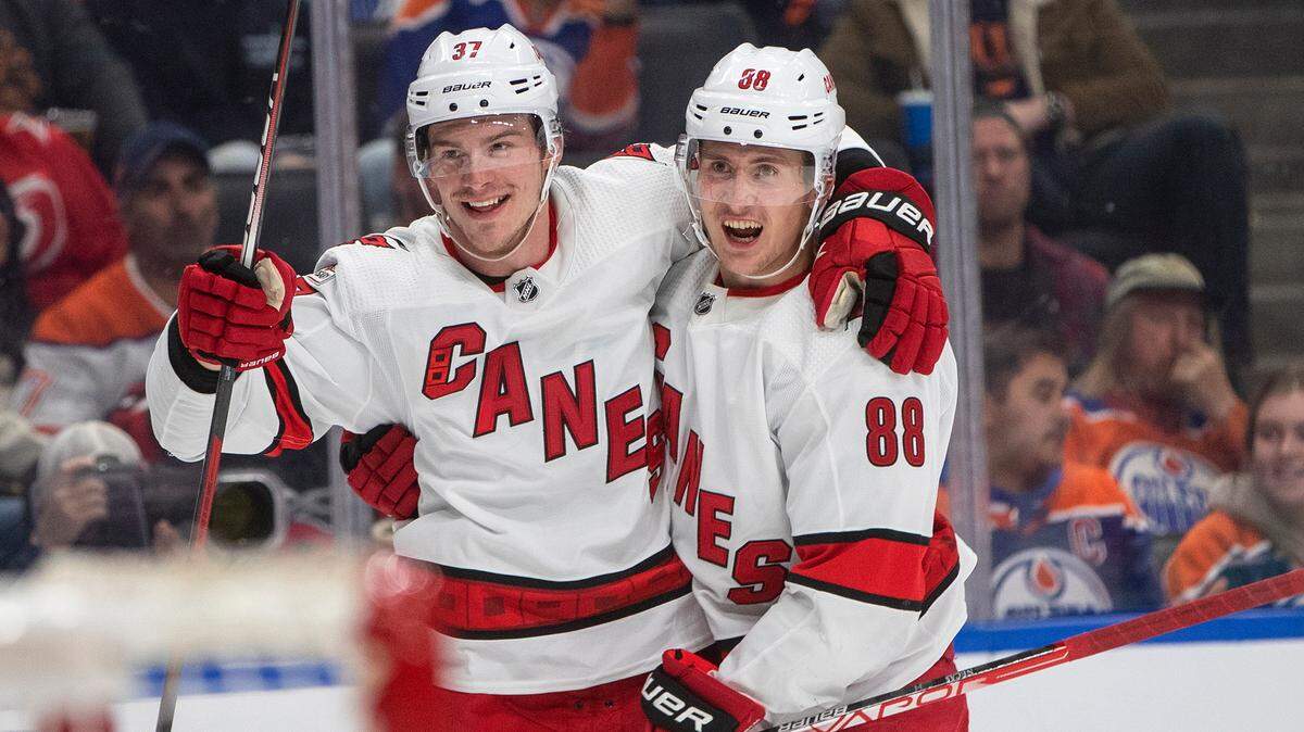 Carolina Hurricanes’ Andrei Svechnikov (37) and Martin Necas (88) celebrate a goal against the Edmonton Oilers during the third period of an NHL hockey game Thursday, Oct. 20, 2022, in Edmonton, Alberta. (Jason Franson/The Canadian Press via AP)