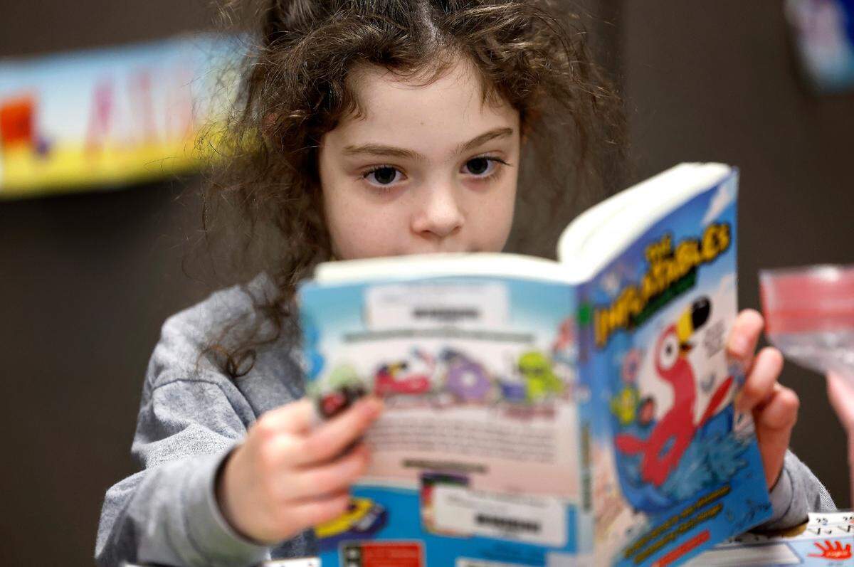 Amelia Copersito reads during her first grade class at St. Mary Magdalene Catholic School in Apex, N.C., Tuesday, Jan. 24, 2024. As of Oct. 6, the school has received $936,152 from the Opportunity Scholarship program for the 2025-26 school year.