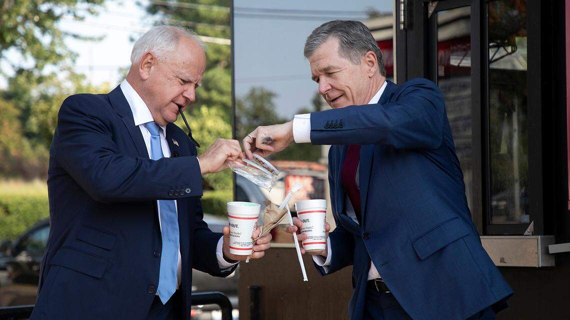Democratic vice presidential candidate Tim Walz (left) and North Carolina Governor Roy Cooper prepare to enjoy milkshakes at the Cookout in Chapanoke Square in Raleigh, Thursday afternoon, Aug. 29, 2024. Walze had a mint chocolate chip shake while Cooper went with an M&M shake.
