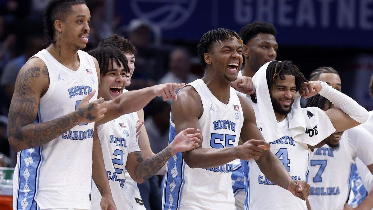 North Carolina players, from left, Armando Bacot (5), Elliot Cadeau (2), Harrison Ingram (55), RJ Davis (4) and the rest of the bench celebrate during second half of UNC’s 92-67 victory over Florida State in the quarterfinal round of the 2024 ACC Men’s Basketball Tournament at Capital One Arena in Washington, D.C., Thursday, March 14, 2024.