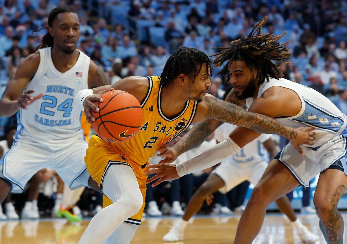 North Carolina’s Jae’Lyn Withers and RJ Davis pressure La Salle’s Corey McKeithan during the second half of the Tar Heels’ 93-67 win on Saturday, Dec. 14, 2024, at the Smith Center in Chapel Hill, N.C.