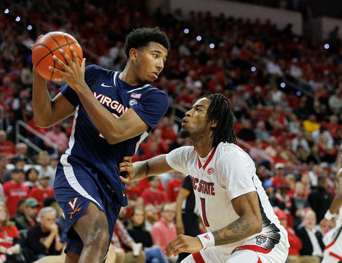 N.C. State’s Jayden Taylor pressures Virginia’s Reece Beekman during the second half of the Wolfpack’s 76-60 win on Saturday, Jan. 6, 2024, at PNC Arena in Raleigh, N.C.