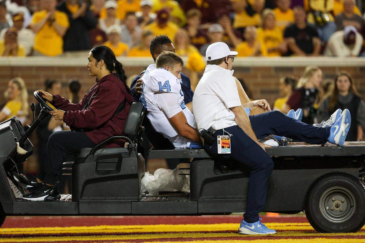 North Carolina Tar Heels quarterback Max Johnson is carted off the field during the second half against the Minnesota Golden Gophers at Huntington Bank Stadium. 