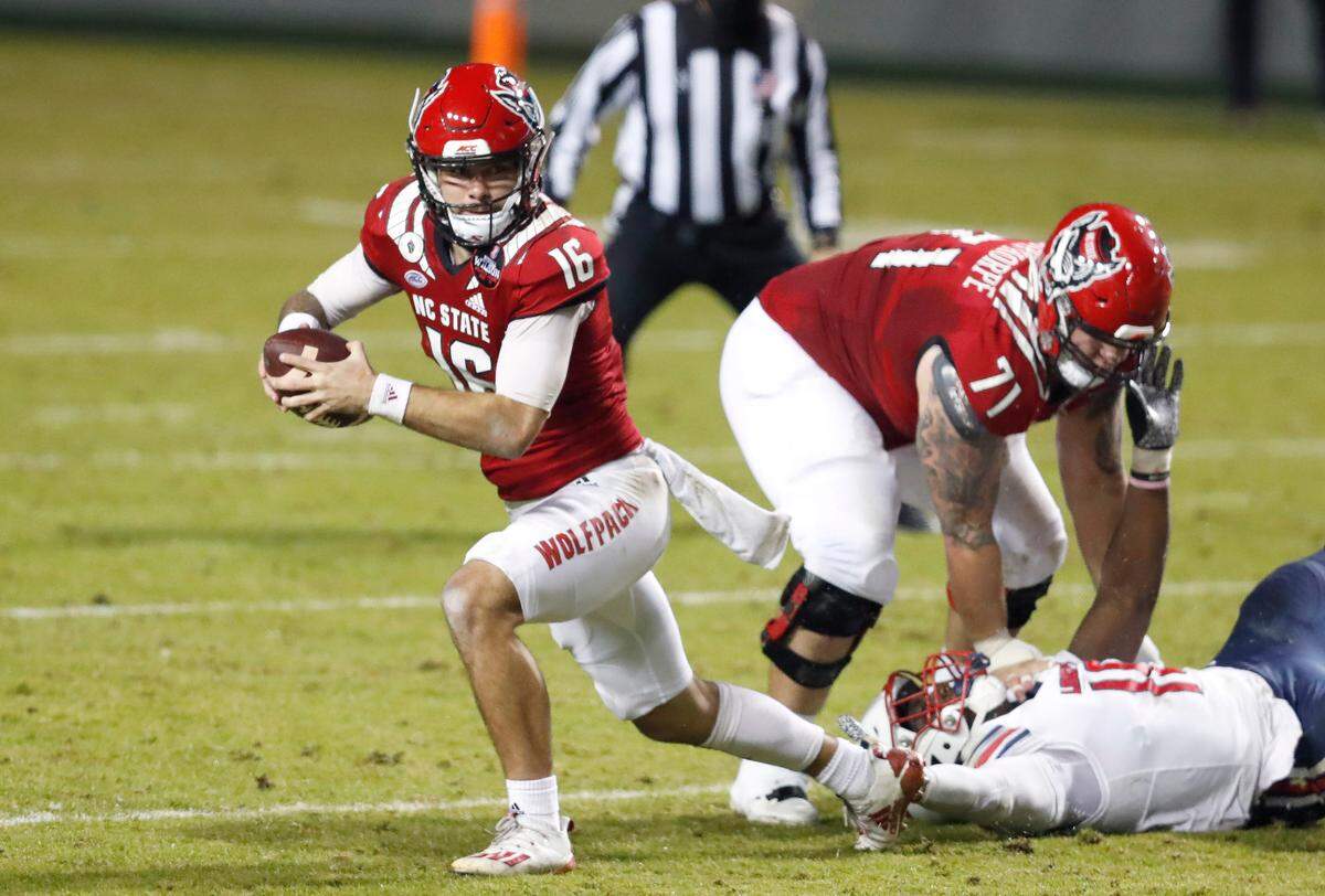 N.C. State quarterback Bailey Hockman (16) escapes from pressure during the first half of N.C. State’s game against Liberty at Carter-Finley Stadium in Raleigh, N.C., Saturday, Nov. 21, 2020.