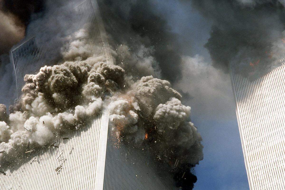 In this Sept. 11, 2001, file photo, the south tower of the World Trade Center, left, begins to collapse after a terrorist attack on the landmark buildings in New York.