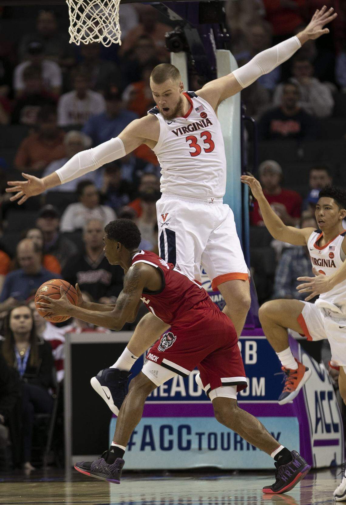 Virginia’s Jack Salt (33) defends N.C. State’s Markell Johnson (11) during the second half on Thursday, March 13, 2019 during quarter finals of the ACC Tournament at Spectrum Center in Charlotte, N.C.