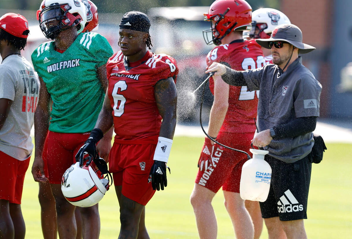 N.C. State safety Jakeen Harris (6) is cooled down during the Wolfpack’s first practice of fall camp in Raleigh, N.C., Wednesday, August 3, 2022.