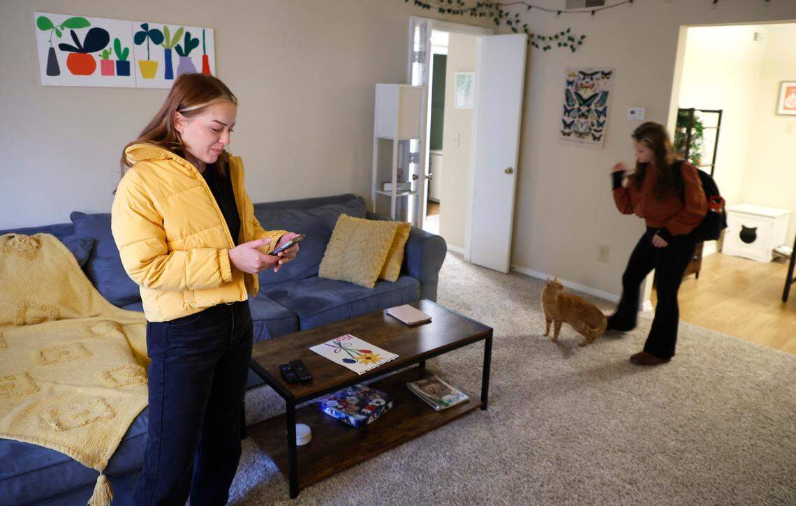 Heather Wilson uses an app to check on the location of the school bus for her daughter, Ady, a fourth-grader at Farmington Woods Elementary School, Thursday morning, Jan. 12, 2023.