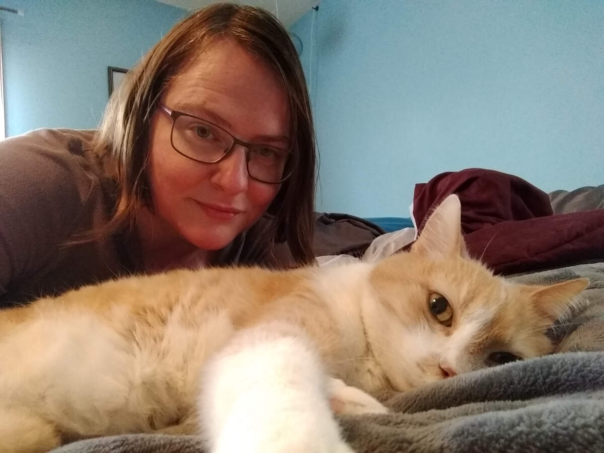 As the Communications Specialist for Orange County Animal Services (OCAS), Tenille Fox and the shelter staff are adapting to change as the Stay At Home Order goes into effect tomorrow. The shelter is considered an essential community service, so they are finding ways to continue to serve people and animals. Fox is pictured at home with her cat, Caesar.