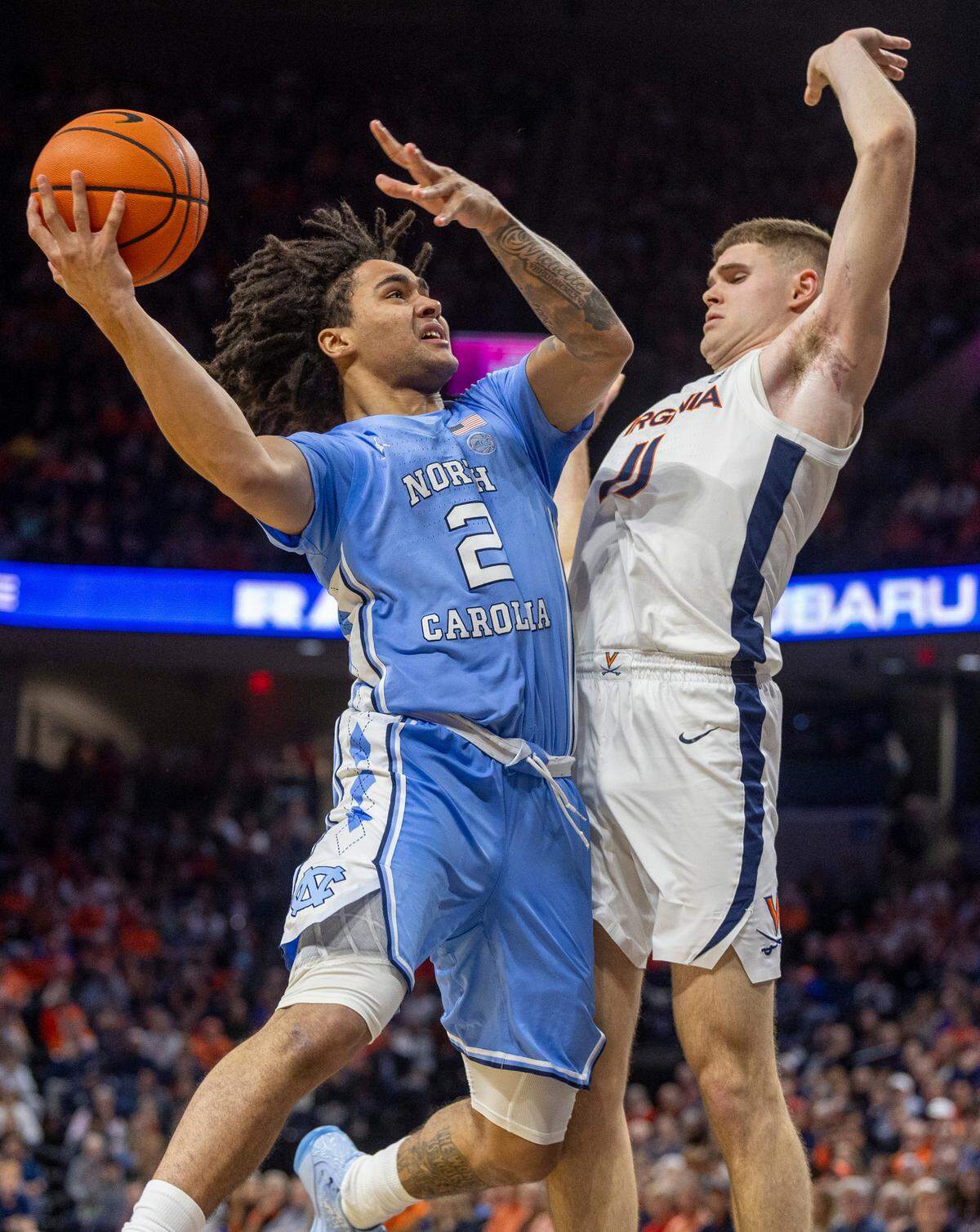 North Carolina’s Elliot Cadeau (2) drives to the basket against Virginia’s Isaac McKneely (11) during the second half on Saturday, February 24, 2024 at John Paul Jones Arena in Charlottesville, Va.