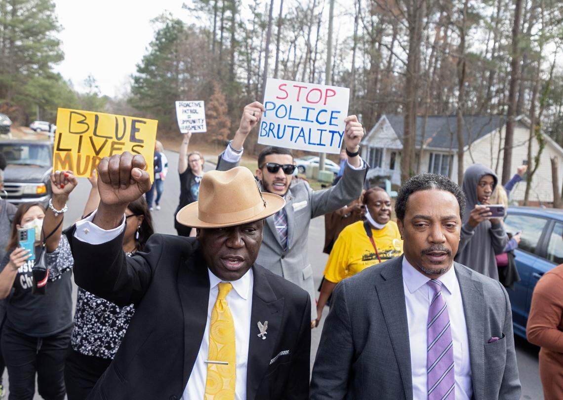 Attorney Ben Crump, left, leads a march on Thursday, Feb. 16, 2023, to the spot where Darryl Williams was tased by the Raleigh Police Department. Williams was tased three times by officers and died shortly afterward.