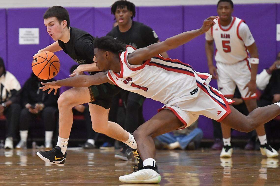 Greenfield's  Johnny Winborne (2)  protects the ball from Coronado's Munir Greig (1) after the steal during the first half. The Greenfield Knights and the Coronado Cougars (Nevada) met in the finals of the Day'Ron Sharpe bracket of the  John Wall Holiday Tournament in Raleigh, N.C. on December 30, 2025.