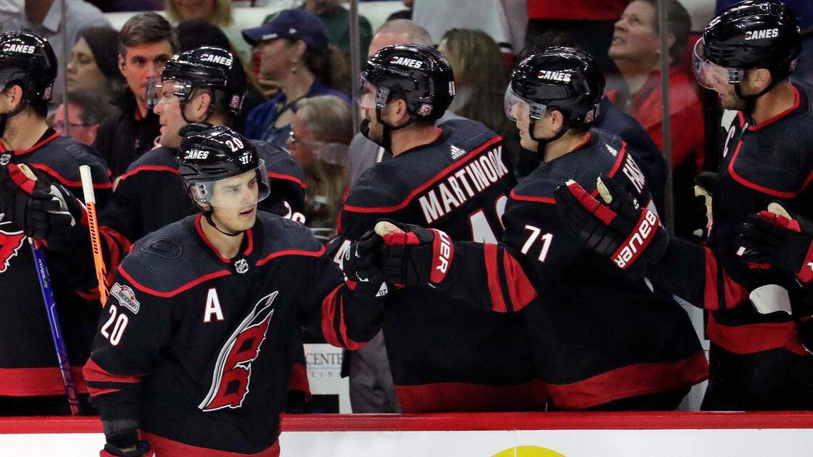 Carolina Hurricanes center Sebastian Aho (20) is congratulated for his second goal of the night as he skates to the bench during the first period of the team’s NHL hockey game against the Buffalo Sabres on Friday, Nov. 4, 2022, in Raleigh, N.C.