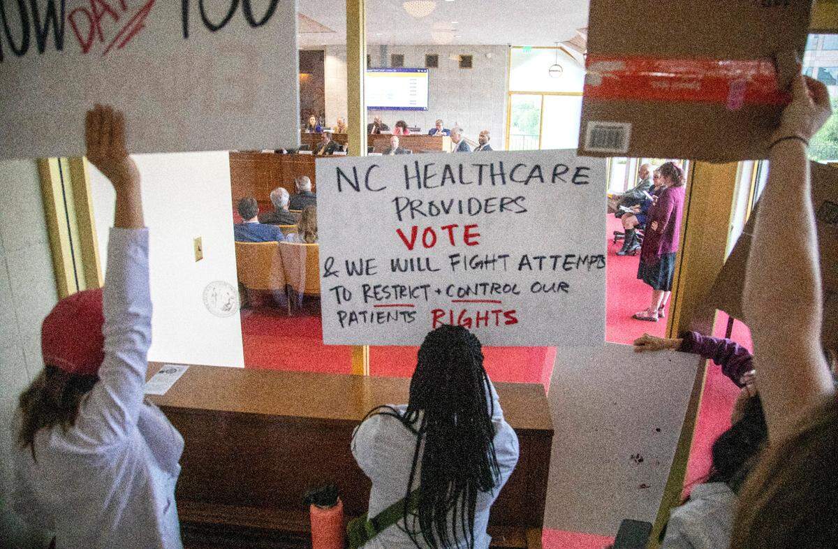 Demonstrators hold signs outside the legislature auditorium where a House Rules meeting&nbsp;was underway, May 3, 2023 at the Legislative Building. Republican state lawmakers announced their plan to limit abortion rights across the state.