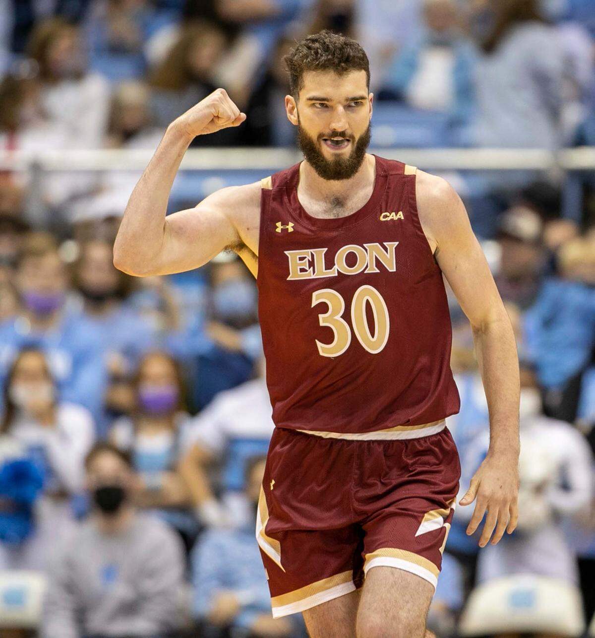 Elon’s Andrew Junkin (30) reacts after a basket and an early lead over North Carolina during the first half on Saturday, December 11, 2021 at the Smith Center in Chapel Hill, N.C.
